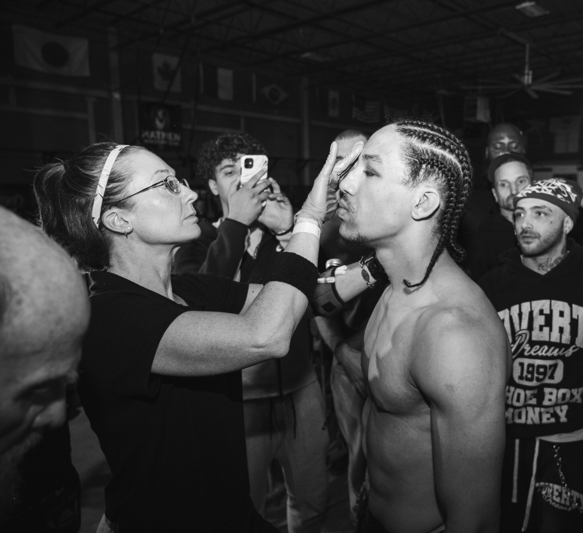 Coach Penny working cutman duties ringside